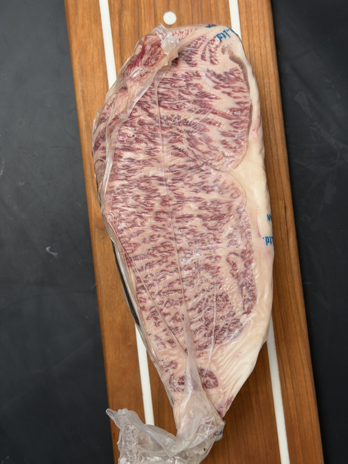 Whole Japanese A5 Wagyu New York strip loin with dense, even marbling