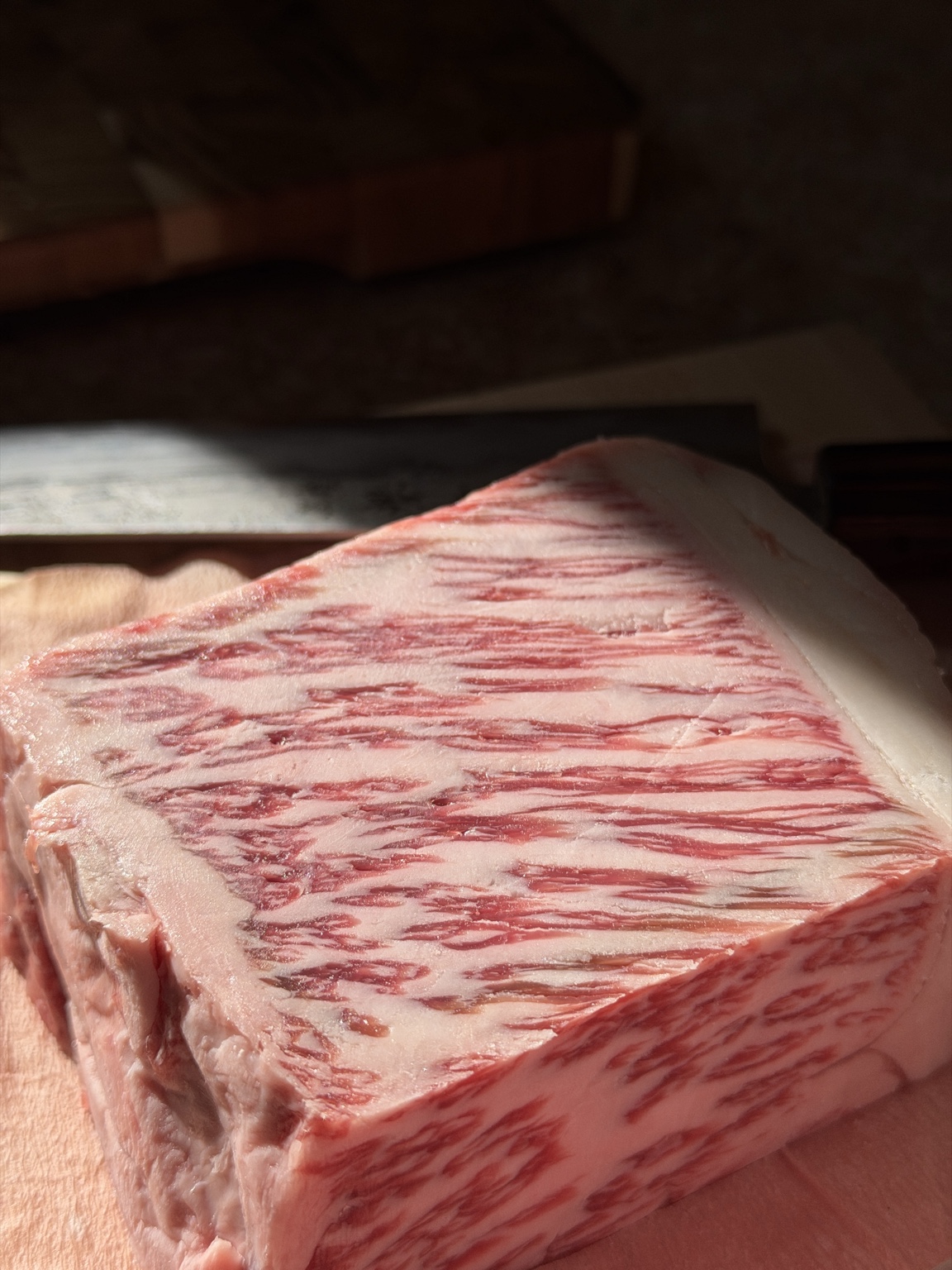 Highly marbled specialty cut resting on a wooden board